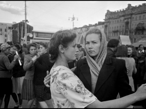 Two Russian women dancing in a crowd in a public square in Moscow.