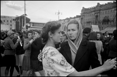 Two Russian women dancing in a crowd in a public square in Moscow.